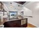 Open-concept kitchen featuring granite countertops, stainless steel appliances, and stunning lake views at 140 Brent Cir, Oldsmar, FL 34677