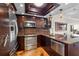 Beautiful kitchen with stainless appliances, wood floors, and custom lighting at 140 Brent Cir, Oldsmar, FL 34677