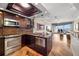 Modern kitchen with stainless appliances, wood floors and open floorplan at 140 Brent Cir, Oldsmar, FL 34677