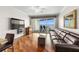 Comfortable living area with hardwood floors, water views, and access to the balcony at 140 Brent Cir, Oldsmar, FL 34677