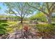 Shaded playground with picnic tables and swing set, surrounded by lush trees and landscaping at 140 Brent Cir, Oldsmar, FL 34677