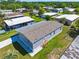Single-story light gray home with a new driveway, stairs to the entry, and set in a lush, green community at 14383 Dehaven Ave, Brooksville, FL 34613