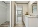 Well-lit bathroom featuring a sink, ample countertop space, and wood-look vinyl floors at 14383 Dehaven Ave, Brooksville, FL 34613