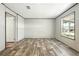 The bedroom features wood-look floors and a window for natural lighting at 14383 Dehaven Ave, Brooksville, FL 34613