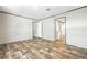 The bedroom has vinyl floors and a view to the bathroom and walk in closet at 14383 Dehaven Ave, Brooksville, FL 34613