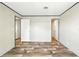 The spacious bedroom has wood floors and doors to the bathroom and closet at 14383 Dehaven Ave, Brooksville, FL 34613
