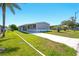 Charming home with a covered carport, well-maintained lawn, and a concrete driveway at 14383 Dehaven Ave, Brooksville, FL 34613