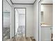 Hallway leading to bathroom showcases modern interiors with a neutral color palette at 14383 Dehaven Ave, Brooksville, FL 34613