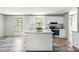 Bright kitchen with a center island, stainless appliances and granite countertops at 14383 Dehaven Ave, Brooksville, FL 34613