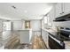 Open-concept kitchen offers stainless steel appliances, island, and a seamless flow to living area at 14383 Dehaven Ave, Brooksville, FL 34613