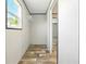 This walk-in closet has vinyl floors and a white wire shelf at 14383 Dehaven Ave, Brooksville, FL 34613