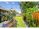 Lush backyard with well-maintained lawn, mature landscaping, and string lights for outdoor ambiance at 1511 Woonsocket Ln, Brandon, FL 33511