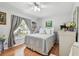Bright bedroom featuring a comfortable bed with a patterned quilt and large window with soft curtains at 1511 Woonsocket Ln, Brandon, FL 33511