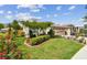 Beautiful home showcasing a well-manicured lawn, mature trees, flowerbeds, and a two-car garage at 1511 Woonsocket Ln, Brandon, FL 33511