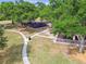 Aerial view of a playground featuring walking paths, play structures, and seating areas at 1511 Woonsocket Ln, Brandon, FL 33511