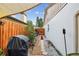 A cozy side yard featuring stone path and a grill, with a fence offering privacy at 1511 Woonsocket Ln, Brandon, FL 33511