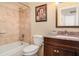 Inviting bathroom with tiled shower-tub, granite countertop vanity, and modern fixtures at 1528 Chevy Chase Dr, Sun City Center, FL 33573