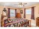 Cozy bedroom featuring a wooden bed frame, dresser, and windows providing natural light at 1528 Chevy Chase Dr, Sun City Center, FL 33573