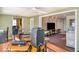 Open entertainment area with hardwood floors, ample space, and a television at 1528 Chevy Chase Dr, Sun City Center, FL 33573