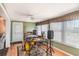 Entertainment area with hardwood floors, a ceiling fan, and many windows at 1528 Chevy Chase Dr, Sun City Center, FL 33573