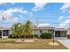 Charming single-story home featuring manicured landscaping and a welcoming facade at 1528 Chevy Chase Dr, Sun City Center, FL 33573