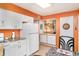 Well-lit kitchen with white cabinetry, granite countertops, and tile flooring at 1528 Chevy Chase Dr, Sun City Center, FL 33573