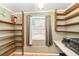 Functional storage room with shelving and a window letting in natural light at 1528 Chevy Chase Dr, Sun City Center, FL 33573
