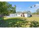 Spacious backyard featuring a lush lawn and patio, perfect for outdoor entertaining and relaxation at 1601 Paloma Ln, Dunedin, FL 34698
