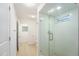 Bathroom featuring a glass shower door with a tiled interior and modern fixtures at 1601 Paloma Ln, Dunedin, FL 34698