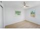 A clean bedroom with two windows providing natural light and a ceiling fan at 1601 Paloma Ln, Dunedin, FL 34698
