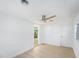 Bright bedroom featuring a ceiling fan and hardwood flooring with ample natural light at 1601 Paloma Ln, Dunedin, FL 34698