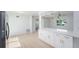 Bright kitchen features stainless appliances, granite countertops, and white cabinets at 1601 Paloma Ln, Dunedin, FL 34698