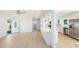 Bright open-concept living room and kitchen featuring new floors and stainless steel appliances at 1601 Paloma Ln, Dunedin, FL 34698
