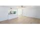 Bright living room features an open layout, seamlessly connecting to the kitchen and dining areas at 1601 Paloma Ln, Dunedin, FL 34698