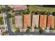 Aerial view of the neighborhood with well-maintained lawns, mature landscaping and picturesque streets at 16055 Golden Lakes Dr, Wimauma, FL 33598