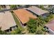 Aerial view of the home showcases its location, screen enclosed porch, mature trees and landscaping at 16055 Golden Lakes Dr, Wimauma, FL 33598