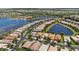 An aerial view showcases the community's desirable waterfront location with a variety of single-Gathering homes at 16055 Golden Lakes Dr, Wimauma, FL 33598