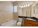 Bright bathroom featuring a tub, toilet, vanity with a dark countertop, and tiled walls at 16055 Golden Lakes Dr, Wimauma, FL 33598