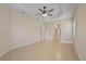 Bright bedroom with neutral walls, tile flooring and a ceiling fan with direct access to other rooms at 16055 Golden Lakes Dr, Wimauma, FL 33598