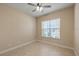 Bright bedroom with a large window, neutral walls, and tile flooring at 16055 Golden Lakes Dr, Wimauma, FL 33598