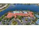 Resort-style community pool and clubhouse with poolside lounging and tennis courts providing recreational opportunities at 16055 Golden Lakes Dr, Wimauma, FL 33598