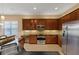 Modern kitchen featuring stainless steel appliances, granite countertops, and custom cabinetry at 16055 Golden Lakes Dr, Wimauma, FL 33598