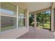 Screened lanai featuring brick pavers and a view of the backyard landscaping with mature trees at 16055 Golden Lakes Dr, Wimauma, FL 33598