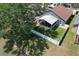An aerial view showcasing the home's backyard, screened lanai, and proximity to a tranquil lake at 1624 Maximilian Dr, Wesley Chapel, FL 33543
