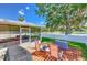 Backyard featuring a deck, lounge chairs, and views of lake at 1624 Maximilian Dr, Wesley Chapel, FL 33543