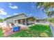 Backyard featuring green grass, wood deck, and enclosed patio at 1624 Maximilian Dr, Wesley Chapel, FL 33543