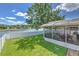 Beautiful backyard with screened-in patio and a lovely lake view, perfect for outdoor relaxation and enjoyment at 1624 Maximilian Dr, Wesley Chapel, FL 33543