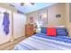 Comfortable bedroom featuring tile flooring, ample closet space, and cozy decor, creating a relaxing ambiance at 1624 Maximilian Dr, Wesley Chapel, FL 33543
