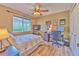 Well-lit bedroom featuring tile floors, a large window, and functional furnishings, perfect for rest and productivity at 1624 Maximilian Dr, Wesley Chapel, FL 33543