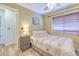 Cozy bedroom featuring wood-look tile floors, neutral walls, and a comfortable bed, creating a peaceful retreat at 1624 Maximilian Dr, Wesley Chapel, FL 33543